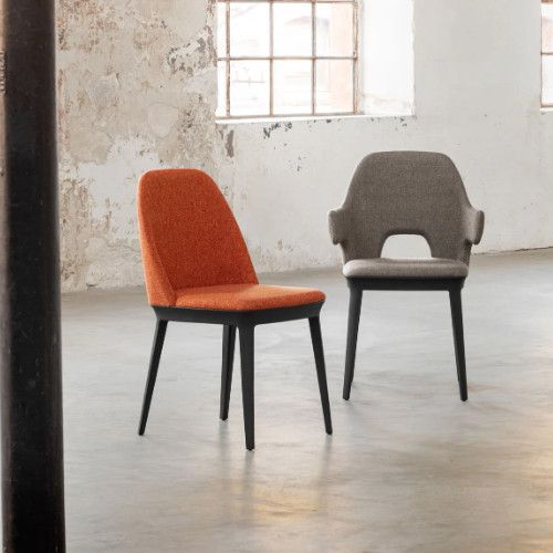 Relay Side Chairs paired in a studio; one features armrests with a cutout design, the other a sleek backless silhouette.