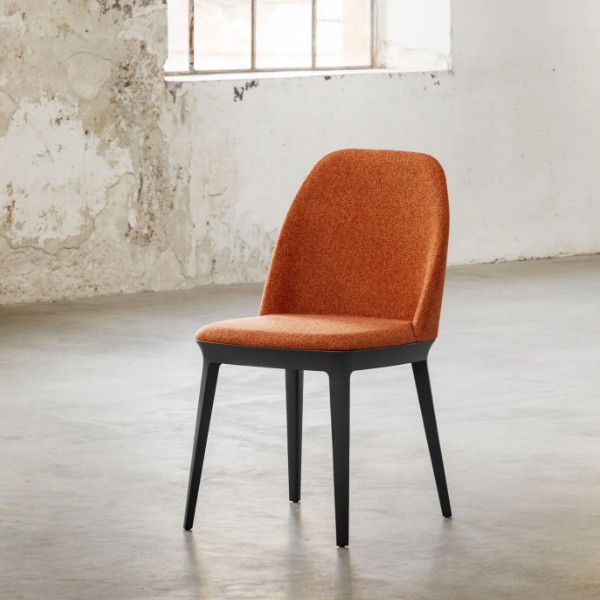 Three-quarter angle of a Relay Side Chair, featuring a burnt-orange upholstered seat on a minimalist black wooden frame.