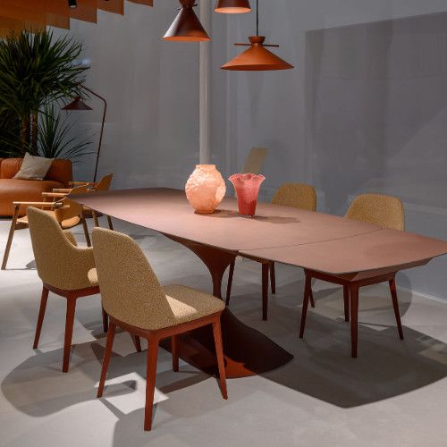 Relay Side Chairs with textured beige seats and wooden frames arranged around a large modern dining table.