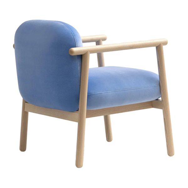 Three-quarter rear angle of the Torri lounge chair showing pale wood legs and soft blue upholstery on a white background.