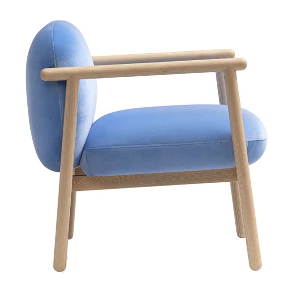 Close-up of the Torri lounge chair showing the light timber armrest detail against soft blue fabric upholstery.