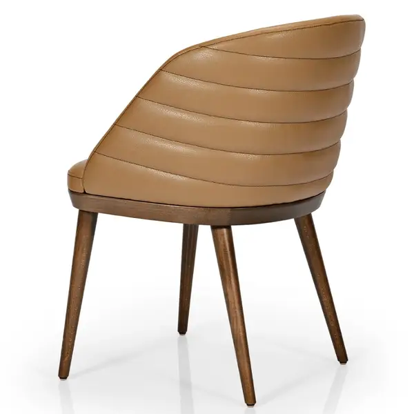 Three-quarter rear view of the Amara side chair featuring tan channel-stitched upholstery and tapered dark timber legs.