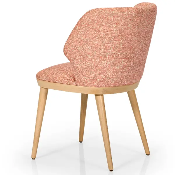 Rear three-quarter view of the Ottom armchair featuring a textured peach upholstered seat and light wooden 4-leg frame.