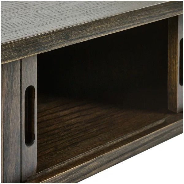 Close-up detail of the Ayra Console Table featuring a dark wood finish and an open storage shelf with rounded cutouts.