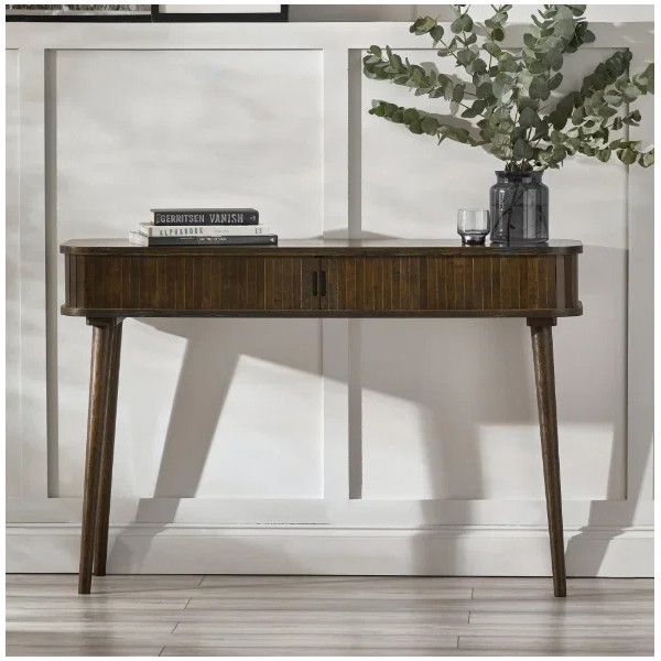 Ayra Console Table front view displaying its rich wood grain, slatted texture, and decorative books and vase.