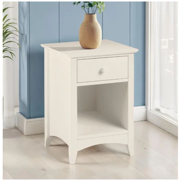 Close-up view of a Cameo 1 Draw Bedside table topped with a wooden vase against a blue wall in a bright, modern room.