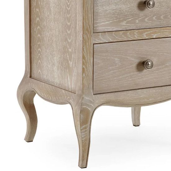 Close-up of Camille bedside table drawers and elegant carved legs, showcasing the textured oak wood grain finish.