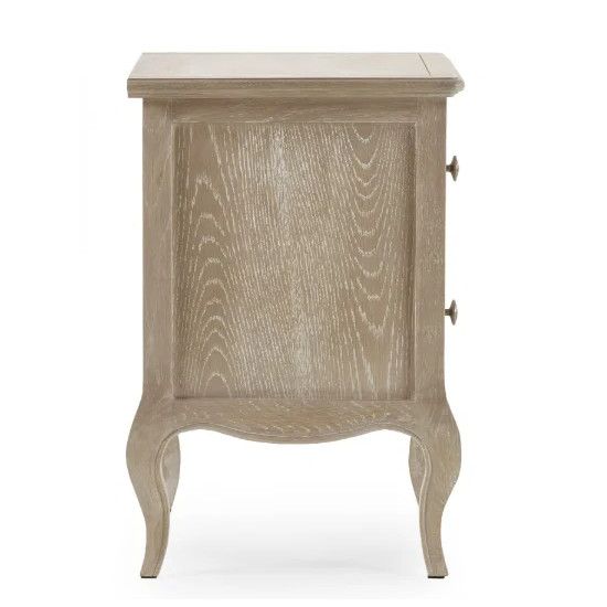 Side profile view of the Camille bedside table showing the natural wood grain finish and elegant curved legs.