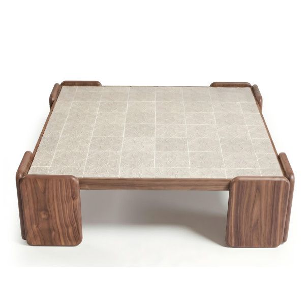 Front view of the Chess Coffee Table featuring a neutral patterned tile surface framed by solid, dark-stained wood legs.
