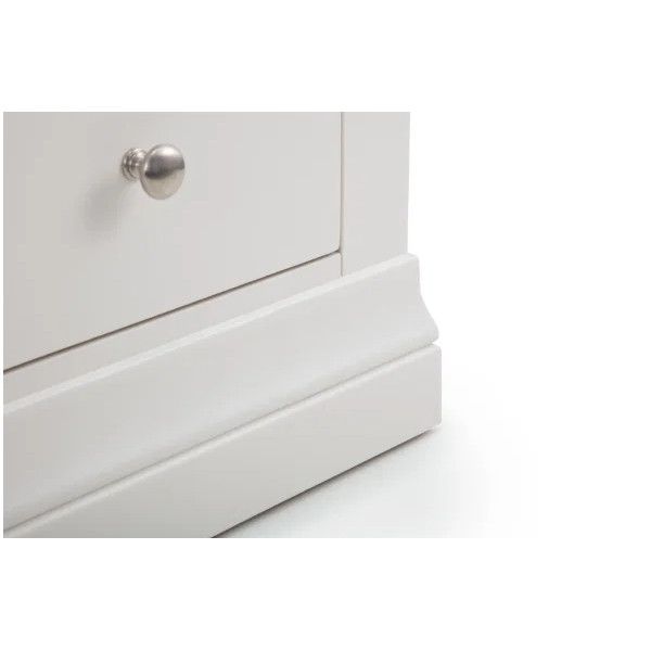 Close-up of the Camille bedside table base, highlighting the smooth white finish, ornate trim, and metallic drawer knob.