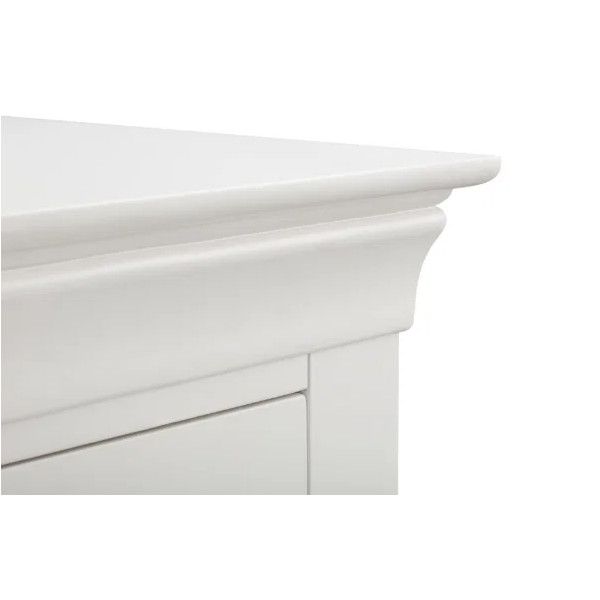 Detail shot of the Camille bedside table top corner, focusing on its smooth white lacquered finish and curved molding.