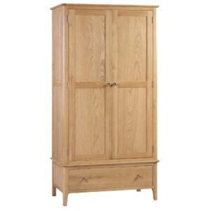 Cotswold wardrobe in natural light oak wood with two doors and a bottom drawer, shown in a front-facing studio view.