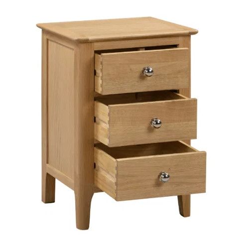 Cotswold Bedside cabinet shown at an angle with three wooden drawers fully extended, featuring simple round chrome pulls.