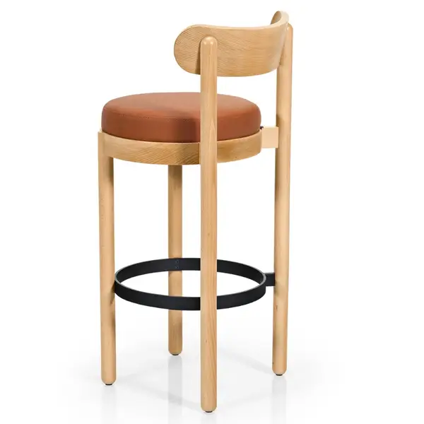 Rear view of the Doris Barstool featuring a tan upholstered seat, wooden frame, and a circular black metal footrest.