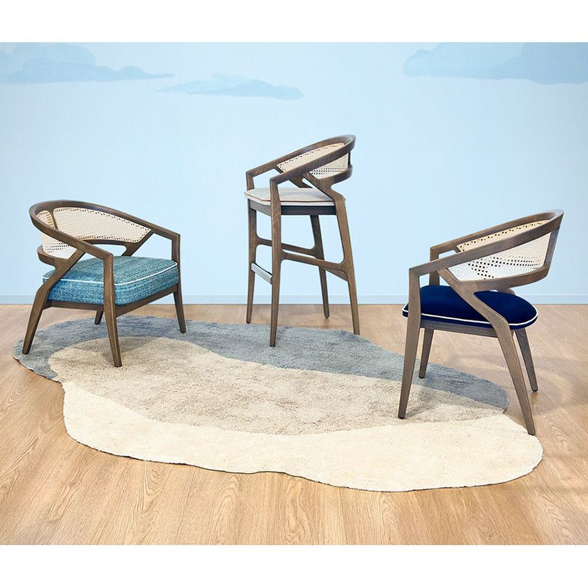 Florence Cane Lounge Chairs and barstool with wooden frames, rattan backrests, and colorful upholstered seats.