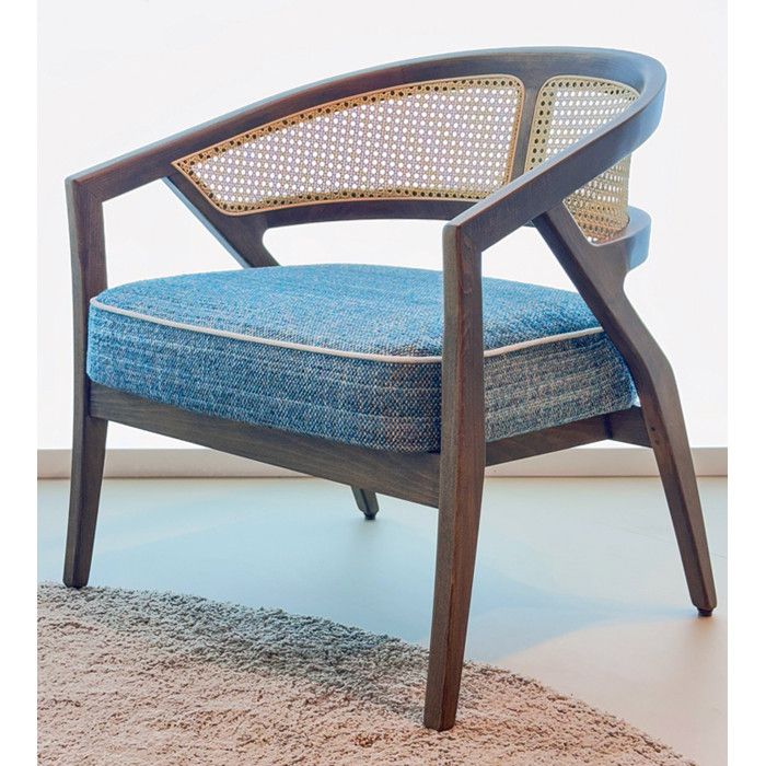 Close-up of a Florence Cane Lounge Chair featuring dark wood, woven rattan back, and a textured blue upholstered seat.