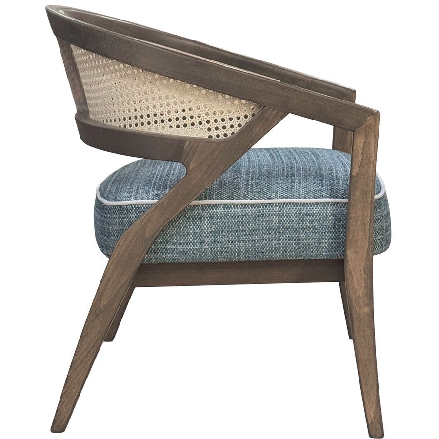 Side profile of the Florence Cane Lounge Chair, showcasing its arched wooden frame, natural rattan back, and blue seat.