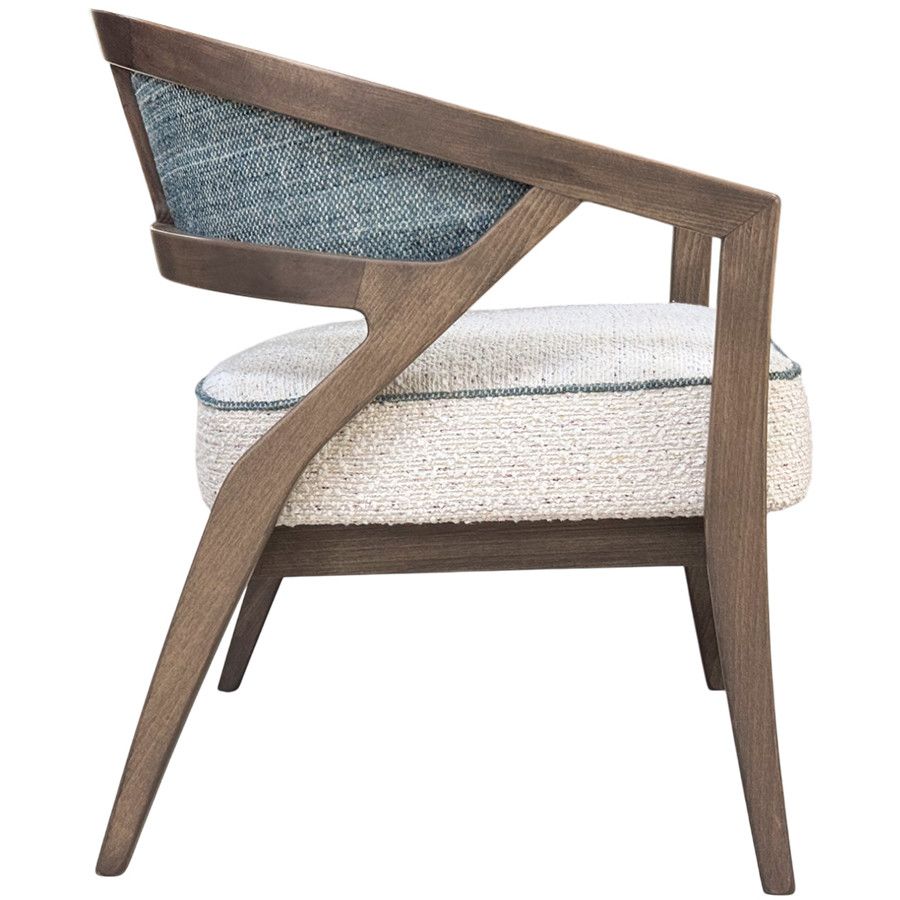 Side profile view of the Florence lounge chair featuring a sculpted wood frame, blue woven back, and cream padded seat.