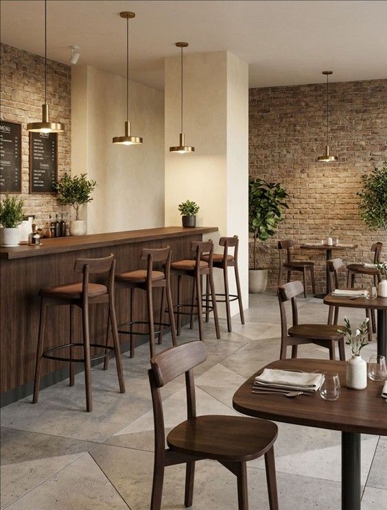 Warm-toned Fondina W Side Chairs arranged in a cozy restaurant setting with rustic brick walls and modern pendant lighting.