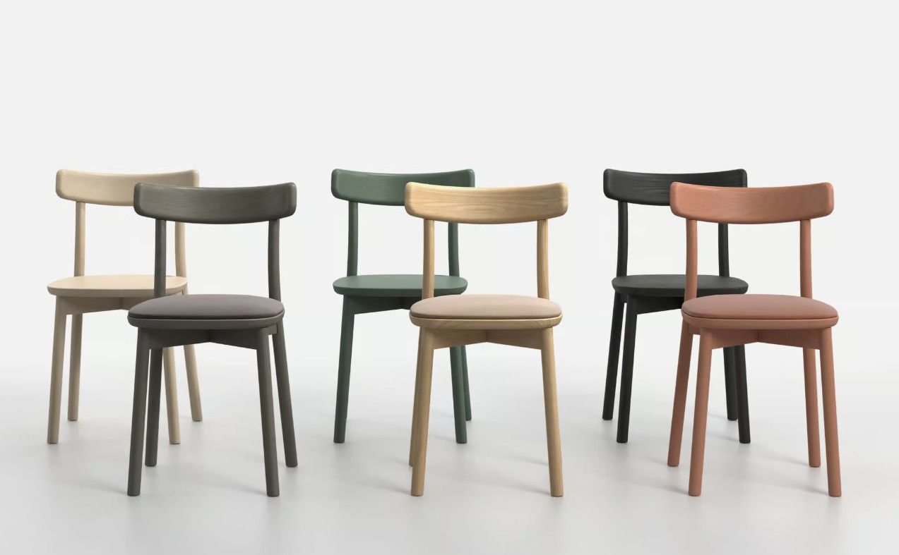 Three pairs of Fondina W Side Chairs in varied colorful finishes arranged in a clean studio display.