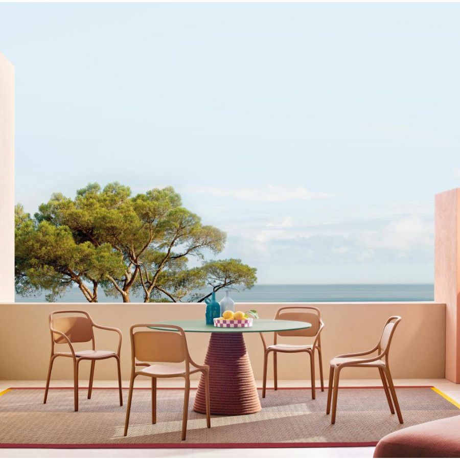 Ikon Twist dining table with a green top and rope-wrapped base, displayed in an outdoor terrace setting with chairs.