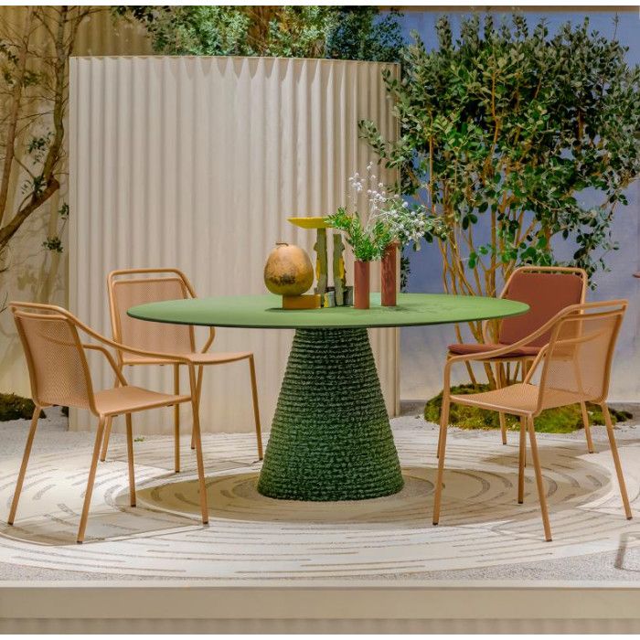 Ikon Twist dining table featuring a round green top and central rope base, surrounded by four modern outdoor chairs.