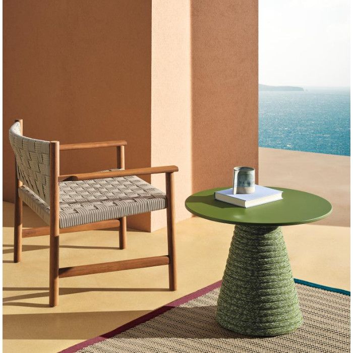 Ikon Twist dining table with a green top and rope-wrapped base, positioned beside a woven wooden chair on a balcony.