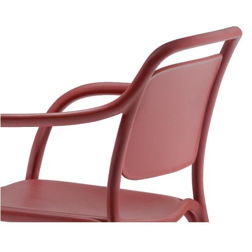 Close-up of a red Libre Armchair featuring a sleek, curved polypropylene frame and integrated armrest design.