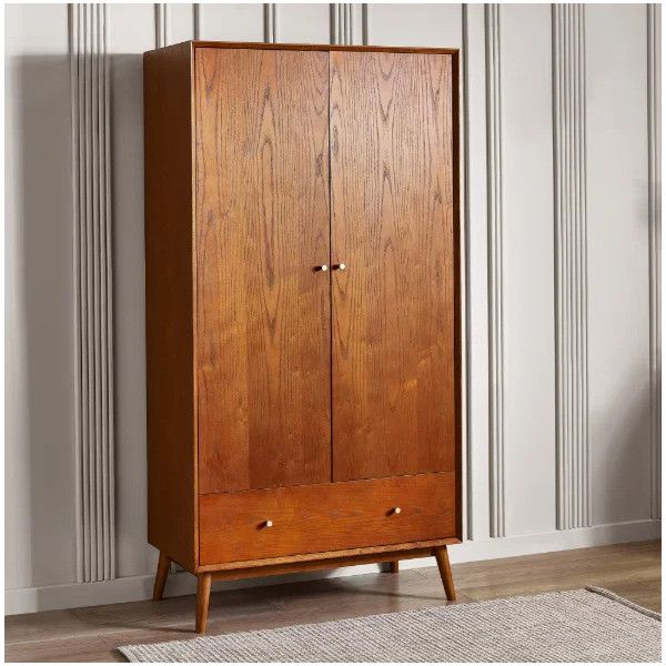 Three-quarter angle view of the Lowry wardrobe showing its solid oak frame, dual doors, and single base storage drawer.