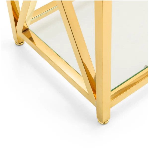 Detail shot of the Miami Console Table base, highlighting the reflective gold angular frame and glass shelf edge.