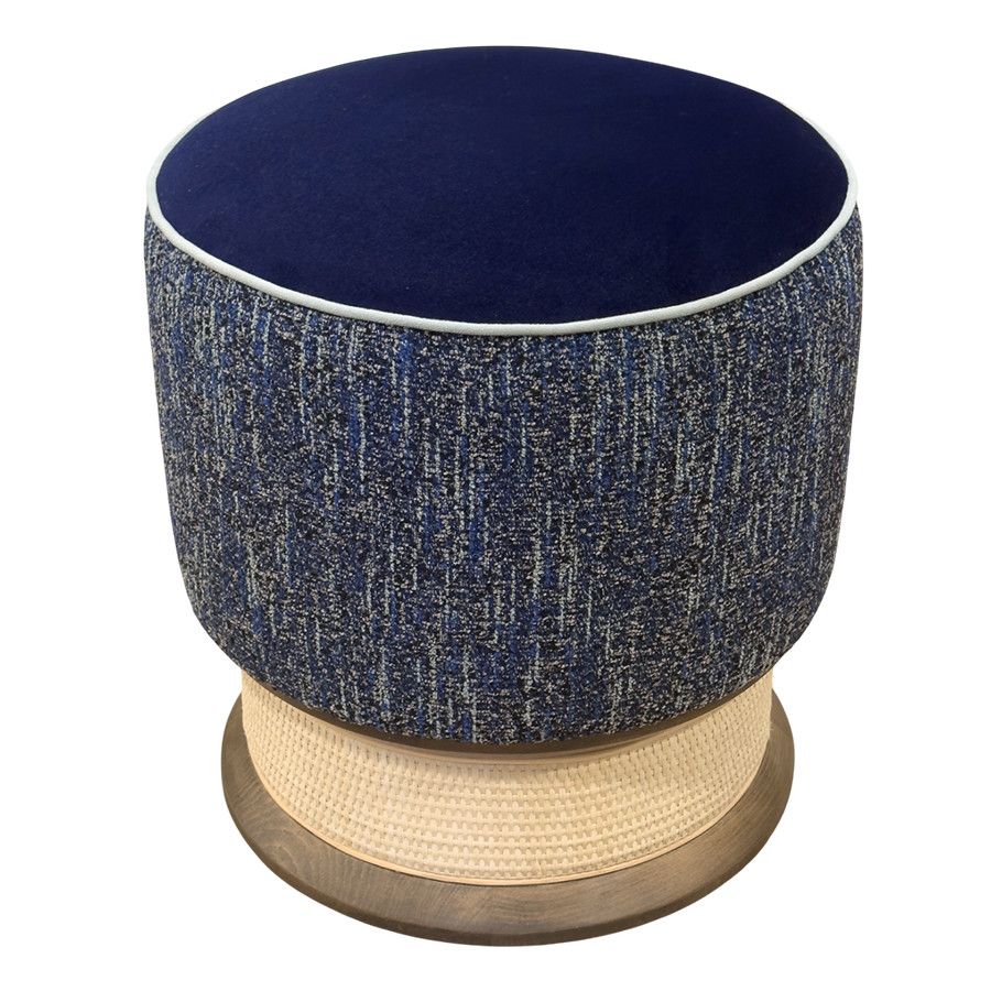 Mira low stool with blue upholstered seat, patterned blue sides, and a natural cane base detail on a wooden pedestal.