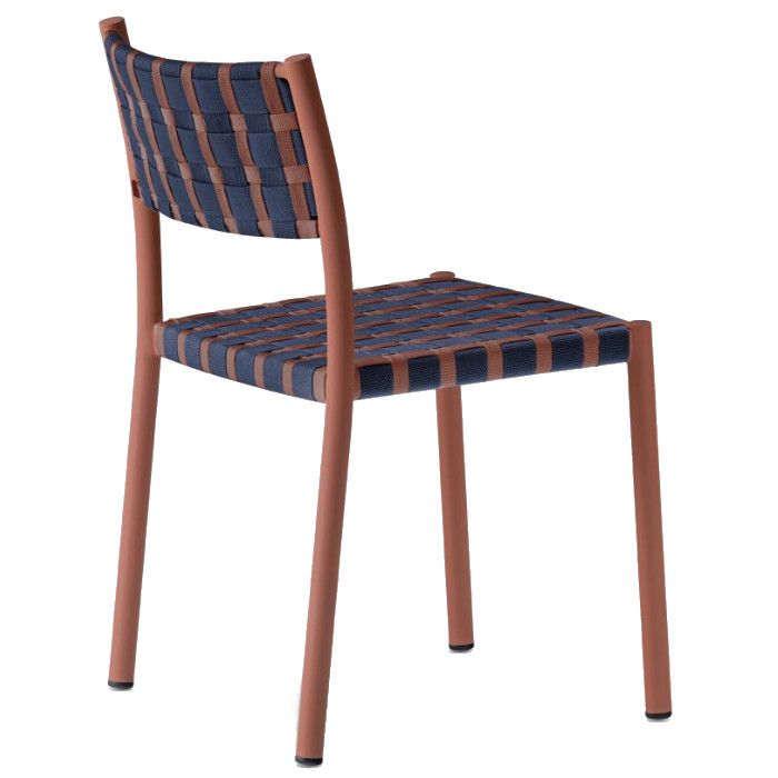Rear three-quarter view of the Nuova Guinea side chair featuring a terracotta metal frame and navy-brown woven seat.
