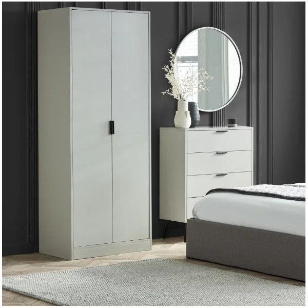 Grey Alba wardrobe with two doors and black handles, showcased in a modern bedroom setting next to a matching chest.