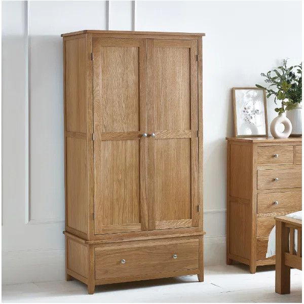 Full-length view of the Mallory 2 Door Wardrobe in oak finish, featuring a bottom storage drawer beside a matching chest.