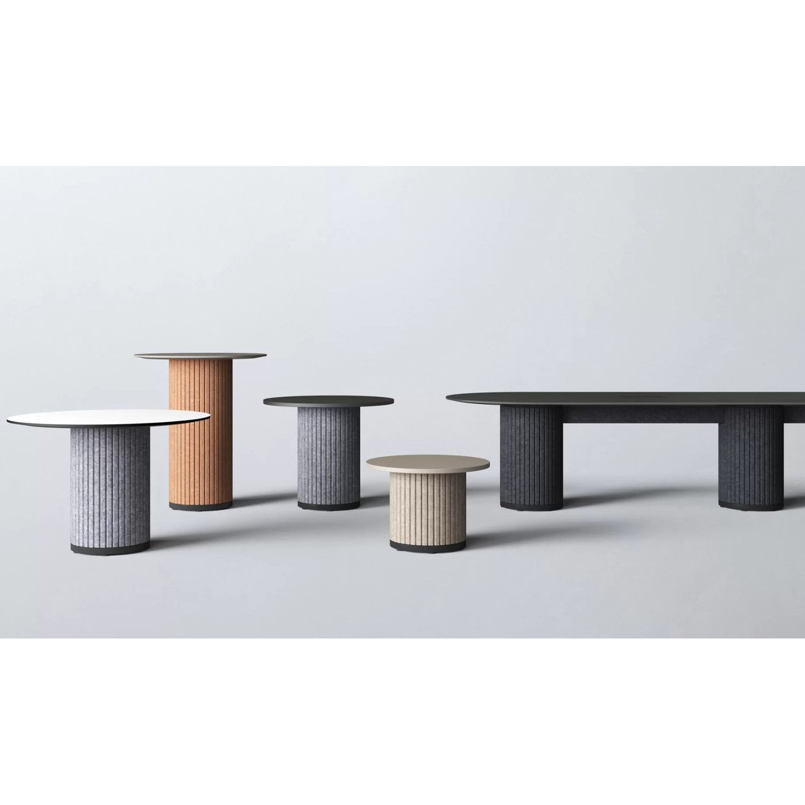 Collection of Parthos meeting tables featuring diverse sizes and heights with fluted, pillar-style bases.