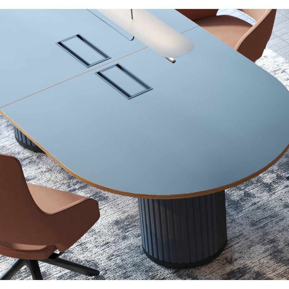 High-angle view of a Parthos meeting table with a light blue top, integrated cable ports, and a fluted grey base.