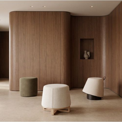 Ballet Low Stool front view with cream upholstered seat on wooden cross base in wood-paneled room.
