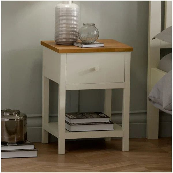 Cream-painted Coxmoor 1 Draw Bedside with an oak top, featuring decorative vases and books in a furnished bedroom setting.