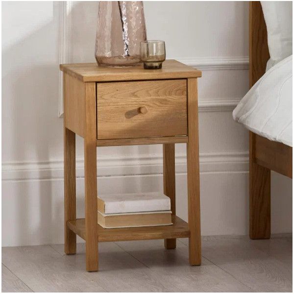 Coxmoor 1 Draw Bedside table in natural oak featuring a styled top surface, single drawer, and lower shelf with books.