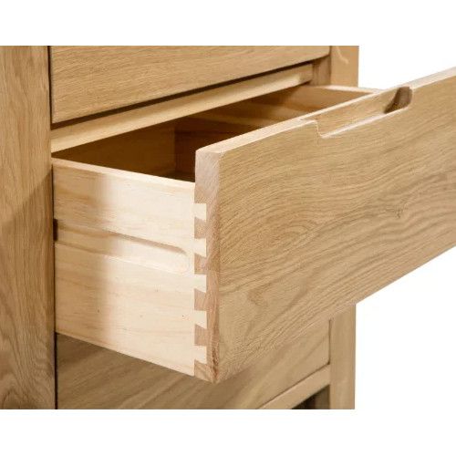 Detailed side view of the Curve Bedside showing the dovetail joinery of an open oak drawer against a plain background.