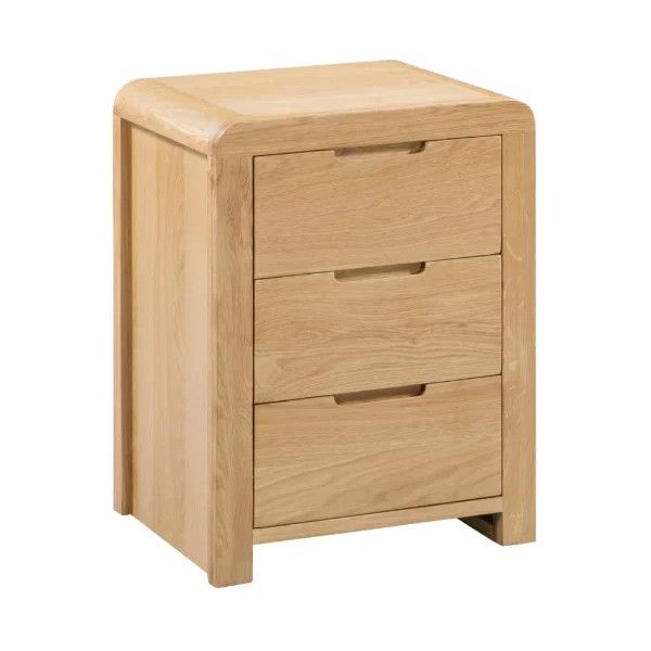 Curve Bedside table in natural oak finish with three drawers and rounded edges, shown from a front-side angle.