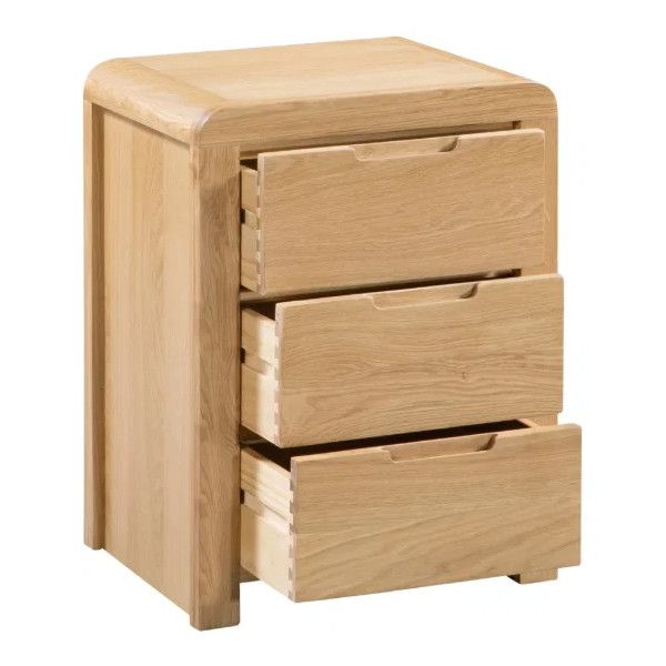 Curve Bedside cabinet in oak with three open drawers, captured in a high-angle studio shot against a white background.