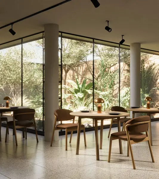 Elia armchair with warm brown upholstery and natural timber frame, showcased in a sunlit restaurant interior.