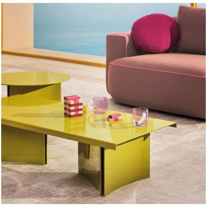 Lime green Estratto metal coffee tables styled in a sunlit lounge with pink accents and coastal views.