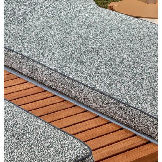 Detail shot of Fibra XL double sun lounger, highlighting speckled grey upholstery against warm teak wooden slats.