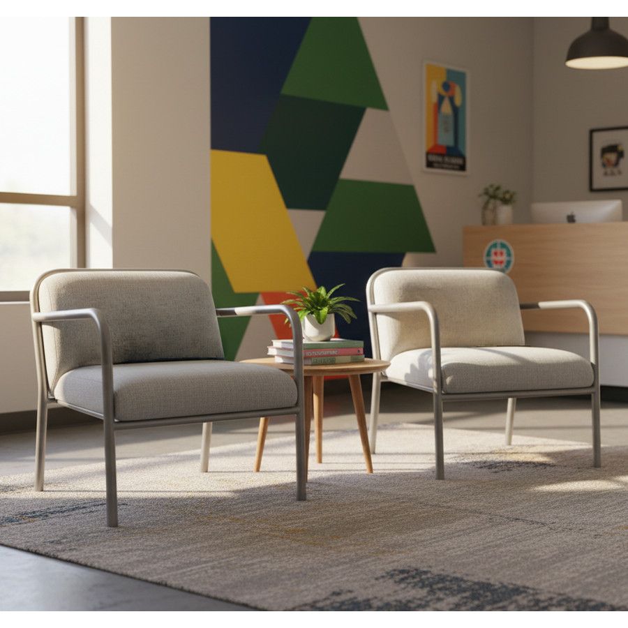 Beige Heidi Armchairs with metal frames arranged around a wooden side table in a vibrant office lounge.