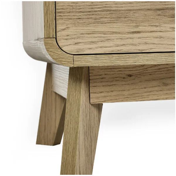 Low angle view of Ingrid bedside table showcasing the soft corner radius of the oak frame and sturdy slanted legs.