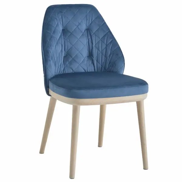 Three-quarter view of Iris Side Chair, showcasing deep blue diamond-stitched velvet and pale wooden tapered legs.