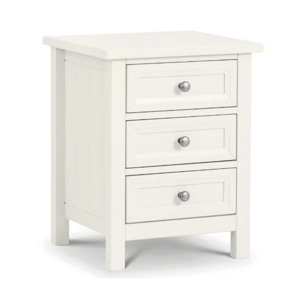 Studio shot of a white Maine bedside table featuring three drawers with silver knobs on a plain white background.