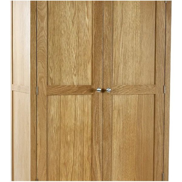 Close-up of the Mallory 2 Door Wardrobe featuring natural oak wood grain and polished silver circular door handles.